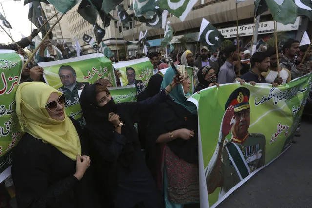 Supporters of former Pakistani military ruler Gen. Pervez Musharraf protest a court's decision, in Karachi, Pakistan, Wednesday, December 18, 2019. The Pakistani court sentenced Musharraf to death in a treason case related to the state of emergency he imposed in 2007 while in power, officials said. Musharraf who is apparently sick and receiving treatment in Dubai where he lives was not present in the courtroom. (Photo by Fareed Khan/AP Photo)