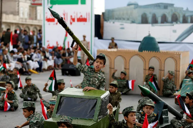A boy holds up a mock rocket launcher during a demonstration marking the annual Al-Quds Day (Jerusalem Day), in Sanaa, Yemen July 1, 2016. (Photo by Khaled Abdullah/Reuters)
