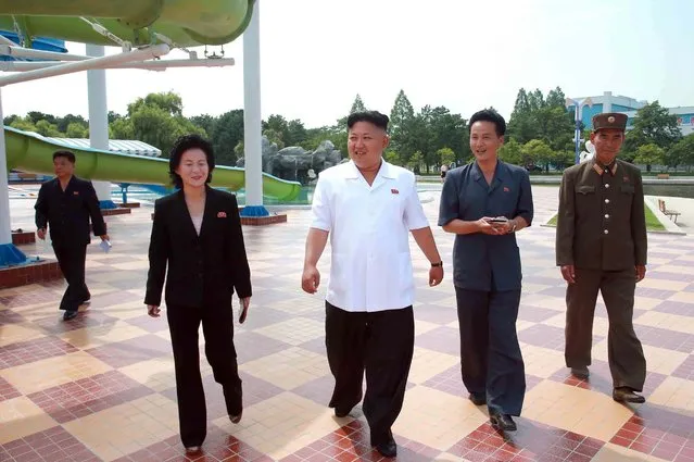 This undated picture released from North Korea's official Korean Central News Agency (KCNA) on July 6, 2014 shows North Korean leader Kim Jong-Un (C) visiting Songdowon International Children's Camp in Wonsan, Kangwon province. (Photo by AFP Photo/KCNA via KNS)