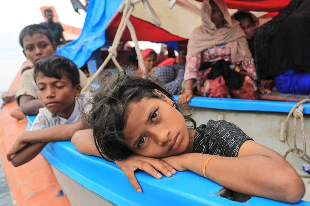 A Rohingya refugee child looks on as she is stranded due to a boat engine failure in the waters of South Aceh, Indonesia on October 23, 2024. (Photo by Syifa Yulinnas/Antara Foto via Reuters)