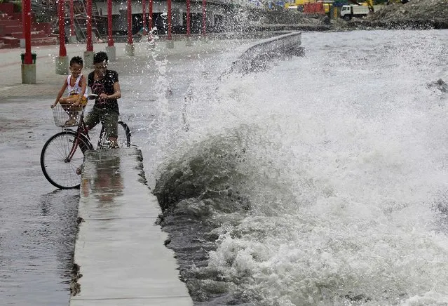 A resident looks on as big waves crash at the coast due to strong winds brought by Typhoon Goni, locally named as Ineng, at the Manila bay in Navotas city, north of Manila August 20, 2015. Typhoon Goni packs a maximum sustained wind of 180kph near the center with gust of up to 215kph as the typhoon maintained its strength moving closer to the extreme northern Luzon provinces, the Philippine Atmospheric, Geophysical and Astronomical Service Administration (PAGASA) state weather bureau reported. (Photo by Romeo Ranoco/Reuters)