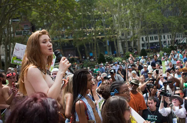 Rachel Jessee speaks to a crowd, consisting mainly of photographers, during a media event following the GoTopless Day Parade in Bryant Park, Sunday, August 23, 2015, in New York. The parade took to the streets to counter critics who are complaining about topless tip-seekers in Times Square. Appearing bare-breasted is legal in New York. (Photo by Kevin Hagen/AP Photo)