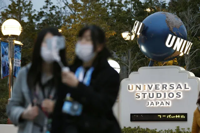 Visitors pose for a selfie in front of Universal Studios Japan in Osaka, western Japan Friday, February 28, 2020. The theme park on Friday announced its temporary closure to prevent the spread of a new coronavirus. (Photo by Kyodo News via AP Photo)