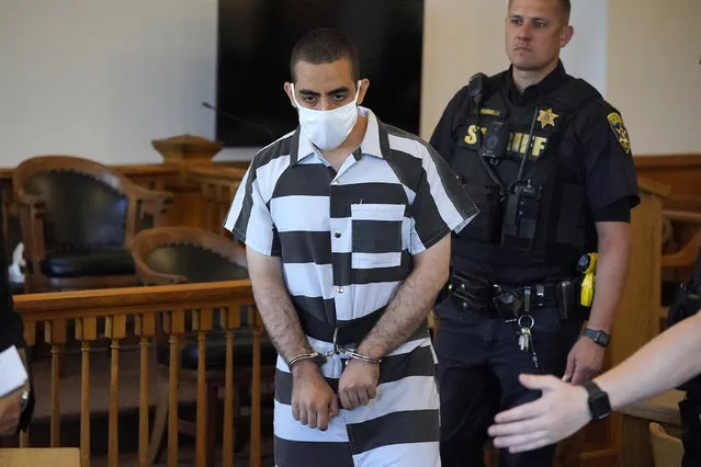 Hadi Matar, 24, center, arrives for an arraignment in the Chautauqua County Courthouse in Mayville, N.Y., Saturday, August 13, 2022. Matar, who is accused of carrying out a stabbing attack against “Satanic Verses” author Salman Rushdie has entered a not-guilty plea in a New York court on charges of attempted murder and assault. An attorney for Matar entered the plea on his behalf during an arraignment hearing. (Photo by Gene J. Puskar/AP Photo)