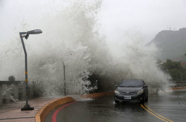A car moves along the shore in Kaohsiung, Southern Taiwan, Wednesday, October 2, 2024, as Typhoon Krathon is expected to hit the area. (Photo by Chiang Ying-ying/AP Photo)
