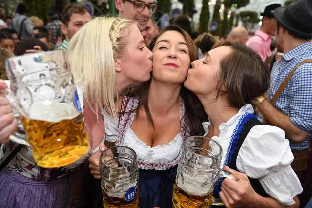 Kick- off of the Oktoberfest in Munich, Germany, 16 September 2017. Visitors celebrate after the tapping at the Hofbraeu (brewery) tent. (Photo by Felix Hörhager/DPA/Bildfunk)