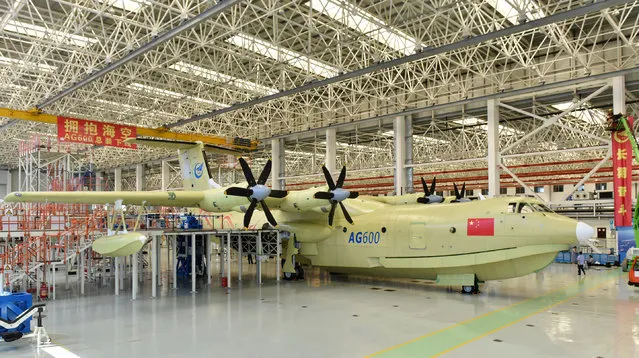 In this Saturday, July 23, 2016 photo released by Xinhua News Agency, the Amphibious aircraft AG600 rolls off a production line in Zhuhai, south China's Guangdong Province. The Xinhua News Agency China said China unveiled the world's largest amphibious aircraft that Beijing plans to use for marine missions and fighting forest fires on Saturday. It measures 37 meters (121 feet) in length with a wingspan of 39 meters (128 feet). (Photo by Liang Xu/Xinhua via AP Photo)