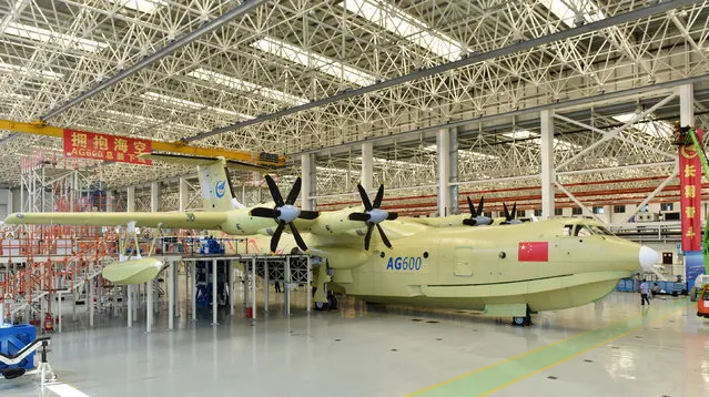 In this Saturday, July 23, 2016 photo released by Xinhua News Agency, the Amphibious aircraft AG600 rolls off a production line in Zhuhai, south China's Guangdong Province. The Xinhua News Agency China said China unveiled the world's largest amphibious aircraft that Beijing plans to use for marine missions and fighting forest fires on Saturday. It measures 37 meters (121 feet) in length with a wingspan of 39 meters (128 feet).  (Photo by Liang Xu/Xinhua via AP Photo)