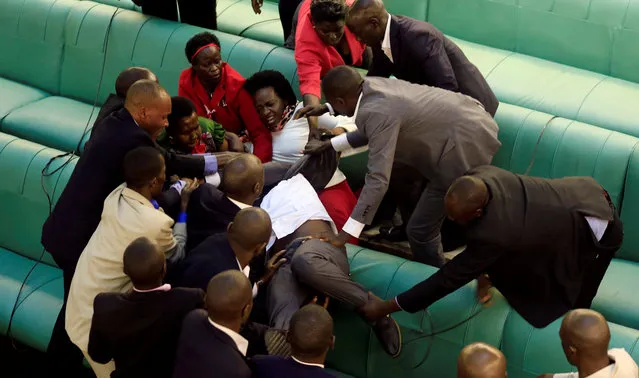 Ugandan opposition lawmakers fight with plain-clothes security personnel in the parliament while protesting a proposed age limit amendment bill debate to change the constitution for the extension of the president's rule, in Kampala, Uganda September 27, 2017. (Photo by James Akena/Reuters)