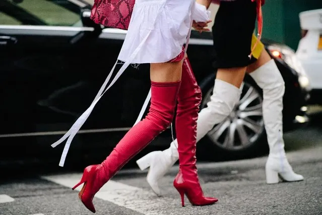 Fashion lovers are seen gathering outside the shows during Paris Fashion Week, France on October 3, 2017. The over-the-knee boot trend is oh-so real this season thanks to Balenciaga, whose spandex boots have been flying off the shelves. Fashionista’s throughout fashion week battled blisters in order to look on-trend in the footwear. (Photo by Katz Sinding)