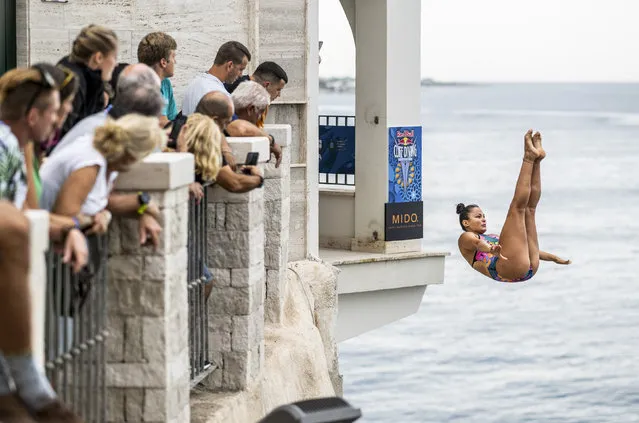In this handout image provided by Red Bull, Maria Paula Quintero of Colombia dives from the 20 metre platform during the first competition day of the seventh stop of the Red Bull Cliff Diving World Series on September 16, 2022 at Polignano a Mare, Italy. (Photo by Dean Treml/Red Bull via Getty Images)