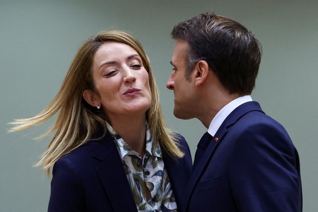 European Parliament President Roberta Metsola reacts as France's President Emmanuel Macron kisses her during a European Union leaders summit, in Brussels, Belgium on December 14, 2023. (Photo by Yves Herman/Reuters)