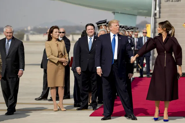 President Donald Trump, second from right, says goodbye to first lady Melania Trump as they arrive at Osan Air Base in Pyeongtaek, South Korea, Tuesday, November 7, 2017. Trump is on a five country trip through Asia traveling to Japan, South Korea, China, Vietnam and the Philippines. (Photo by Andrew Harnik/AP Photo)