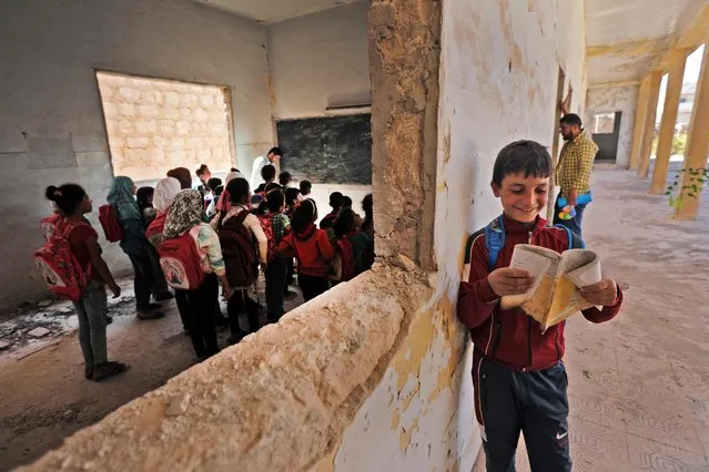 Syrian school children stand in a classroom in a makeshift school in the rebel-held side of the divided northern town of Tadif, located about 32 kilometres (20 miles) east of Aleppo city, on September 26, 2022. (Photo by Bakr Alkasem/AFP Photo)