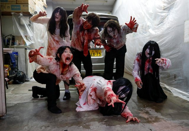 Actors dressed as zombies or ghouls pose for a photograph before their performance at a drive-in haunted house show by Kowagarasetai (Scare Squad), for people inside a car in order to maintain social distancing amid the spread of the coronavirus disease (COVID-19), at a garage in Tokyo, Japan on July 3, 2020. (Photo by Issei Kato/Reuters)