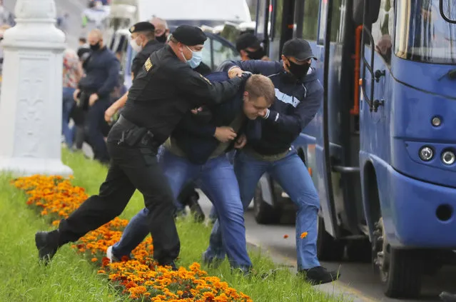 Police officers detain a protester during a rally against the removal of opposition candidates from the presidential elections in Minsk, Belarus, Tuesday July 14, 2020. (Photo by Sergei Grits/AP Photo)