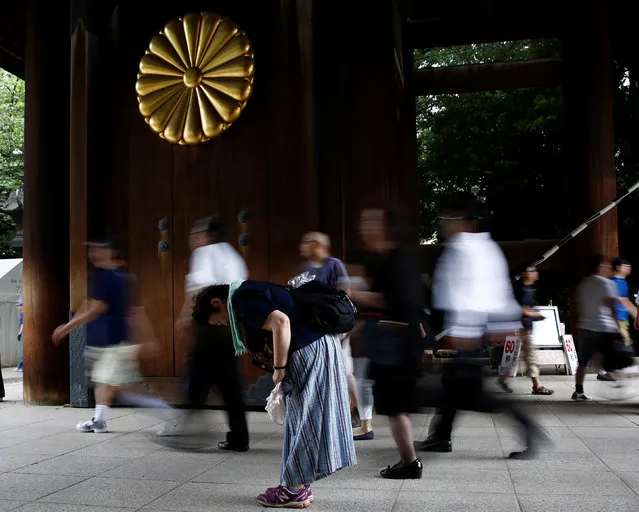 A woman bows as she enters Yasukuni Shrine on the anniversary of Japan's surrender in World War Two in Tokyo, Japan, August 15, 2016. (Photo by Kim Kyung-Hoon/Reuters)