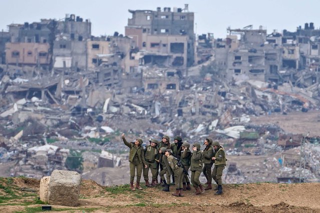 Israeli female soldiers pose for a photo on a position on the Gaza Strip border, in southern Israel, Monday, February 19, 2024. (Photo by Tsafrir Abayov/AP Photo)