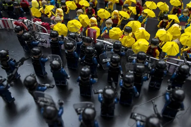 Toy Lego characters depicting a scene of protesters confronting riot police are seen on a table outside the government headquarters in Hong Kong October 20, 2014. A deepening sense of impasse gripped Hong Kong on Monday as pro-democracy protests entered their fourth week, with the government having limited options to end the crisis and demonstrators increasingly willing to confront police. (Photo by Tyrone Siu/Reuters)