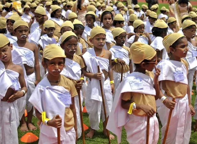 School children dressed as Mahatma Gandhi take part in an attempt to set a new Guiness World Record, for the largest gathering of people dressed as Gandhi, during celebrations to mark the 146th birth anniversary of Gandhi, in Bengaluru, India, October 2, 2015. Mahatma Gandhi, also known as "Father of the Nation", was instrumental in India's struggle for independence from Britain and was a devoted follower of non-violent protest and religious tolerance. (Photo by Abhishek N. Chinnappa/Reuters)