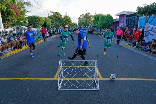 Salvadoran youth from an amputee soccer team participate in soccer matches within the framework of the Street Soccer Champion of Champions final in a community in the city of Soyapango, in San Salvador, El Salvador on December 19, 2022. Due to the existence of gangs in cities and neighborhoods, this sport keeps young people from engaging in violence and crime. It is part of the activities of Phase 2 of the Territorial Control Plan announced by the Salvadoran President Nayib Bukele, which is intended to keep young people away from gang violence through recreational activities, and is organized by the United Nations High Commissioner for Refugees (UNHCR), the Directorate for the Reconstruction of the Social Fabric of El Salvador. (Photo by Alex Pena/Anadolu Agency via Getty Images)