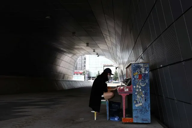 A woman wears a mask and play the piano at at Dongdaemun Design Plaza (DDP) on August 19, 2020 in Seoul, South Korea. South Korea's daily new virus cases have now soared by three-digit figures for a week straight as the country on Wednesday reported the largest number of cases since early March, with infections traced to churches in the capital city of Seoul continuing to swell. The country added 297 more COVID-19 cases, including 283 local infections, raising the total caseload to 16,058, according to the Korea Centers for Disease Control and Prevention (KCDC). (Photo by Chung Sung-Jun/Getty Images)