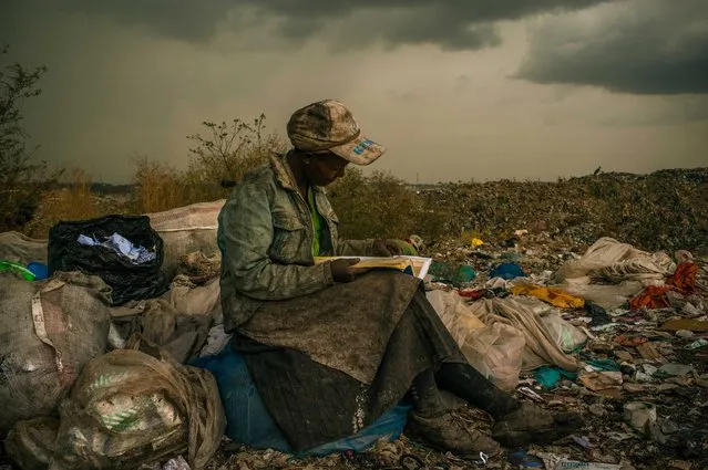 This picture by US photographer Micah Albert, freelance documentary photographer represented by Redux Pictures photo agency is the 1st Prize Contemporary Issues Single in the 56th World Press Photo Contest, it was announced by the organizers on 15 February 2013 in Amsterdam, The Netherlands. Pausing in the rain, a woman working as a trash picker at the 30-acre dump, which literally spills into households of one million people living in nearby slums, wishes she had more time to look at the books she comes across. She even likes the industrial parts catalogs. “It gives me something else to do in the day besides picking trash”, she said. This is picture is dated 03 April 2012 in Nairobi, Kenya. (Photo by Micah Albert/EPA)