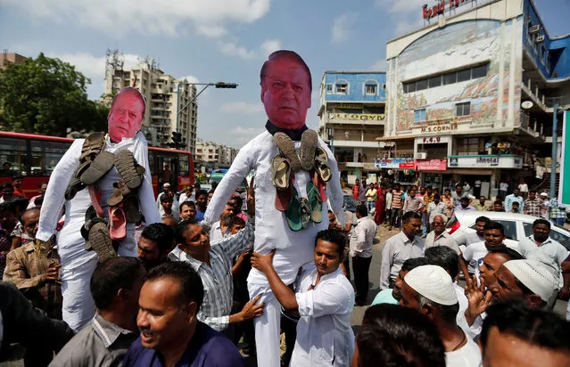 People carry effigies of Pakistan’s Prime Minister Nawaz Sharif to burn them during a protest against Sunday's attack at an Indian army base camp in Kashmir's Uri, in Ahmedabad, India, September 21, 2016. (Photo by Amit Dave/Reuters)