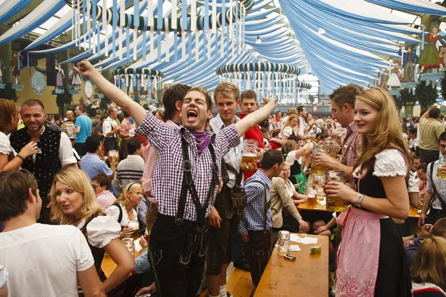 Revellers in traditional costumes celebrate Oktoberfest in the Ochsenbraterei beer tent at Theresienwiese fairgrounds in Munich, Bavaria, Germany, Europe, 2015. (Photo by Michael Taylor/Getty Images/Lonely Planet Images)