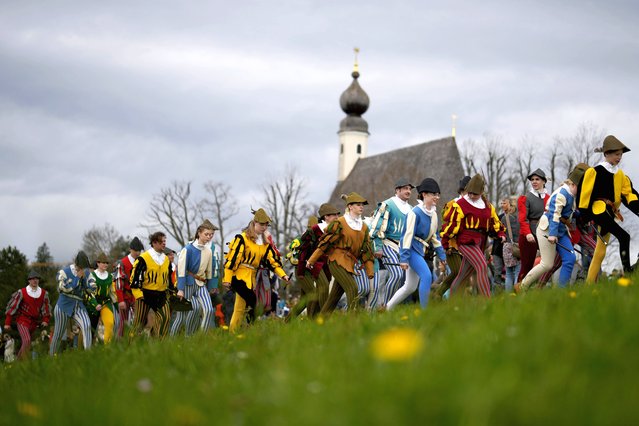 Local residents of the region wearing traditional costumes make their way to get blessings for men and animals, at the St. George church in Traunstein, Germany, Monday, April 1, 2024. (Photo by Matthias Schrader/AP Photo)