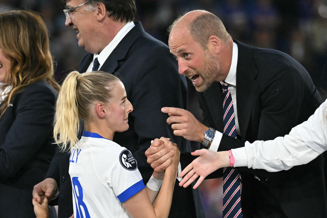 Britain's Prince William, Prince of Wales, shakes hands with England's forward #18 Chloe Kelly after England beat Spain to win the UEFA Women's Euro 2025 final football match between England and Spain at the St. Jakob-Park Stadium in Basel, on July 27, 2025. Chloe Kelly converted the decisive kick as England beat Spain 3-1 on penalties to win the Women's Euro 2025 final had finished 1-1 at the end of extra time, allowing the Lionesses to avenge their defeat in the World Cup final of two years ago and retain their continental crown. (Photo by Fabrice Coffrini/AFP Phoot)