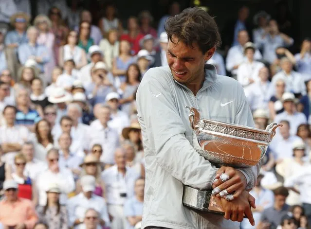 Rafael Nadal of Spain cries during the trophy ceremony after defeating Novak Djokovic of Serbia during their men's singles final match to win the French Open tennis tournament at the Roland Garros stadium in Paris, in this June 8, 2014 file photo. (Photo by Jean-Paul Pelissier/Reuters)