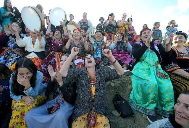 Women spectators cheer during a match in an annual local soccer tournament played by all-women teams, at the village of Sahel, Algeria on October 16, 2020. Algerian women in bright Berber dress ululating, singing and beating drums at the tournament last week were pushing their fight for gender equality - a cause that has come under greater scrutiny in Algeria after a brutal attack this month. (Photo by Ramzi Boudina/Reuters)