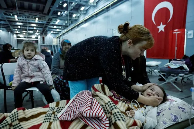 Suleyman, 1, rests in a makeshift hospital bed suffering from exposure, which has been set up in the Turkish military tank landing ship TCG Bayraktar, in the aftermath of a deadly earthquake, docked in a port in the province of Hatay, in Iskenderun, Turkey on February 16, 2023. (Photo by Clodagh Kilcoyne/Reuters)