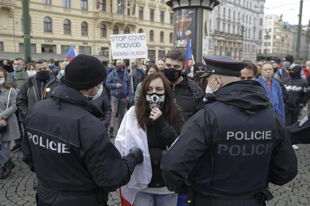 Demonstrators gather to protest the COVID-19 preventative measures downtown Prague, Czech Republic, Wednesday, October 28, 2020. (Photo by Petr David Josek/AP Photo)