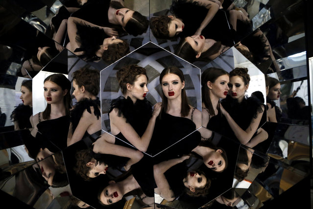 Models pose for a selfie in a mirror hexagon backstage during the Mercedes-Benz Fashion Week Russia in Moscow, Russia, 12 March 2018. The fashion week will run until 17 March. (Photo by Maxim Shipenkov/EPA/EFE)