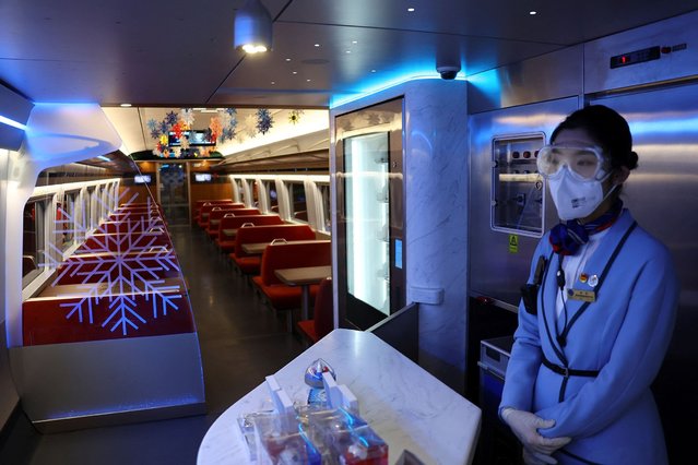 Chinese railway staff is pictured inside the high-speed trains to the mountain area at Qinghe railway station inside a closed loop area designed to prevent the spread of the coronavirus disease (COVID-19) ahead of the Beijing 2022 Winter Olympics in Beijing, China on January 25, 2022. (Photo by Fabrizio Bensch/Reuters)