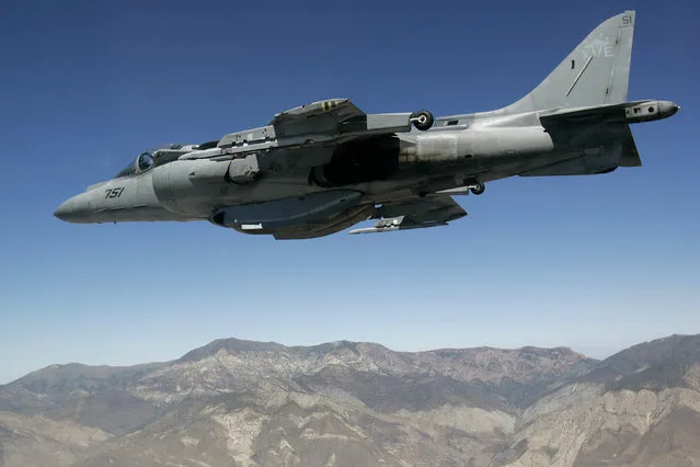 In this June 21, 2007 file photo, a U.S. Marine Corps AV-8 Harrier fighter jet from VX-9 Naval Air Weapons Station China Lake is seen on a training flight from the cockpit of an F-16 based at the California Air National Guard's 144th Fighter Wing over California. A U.S. Marine Corps AV-8 Harrier fighter jet, the same type shown in this photo, crashed Thursday, September 22, 2016, into the ocean off the coast of southwestern Okinawa in Japan, but the pilot ejected safely from the aircraft and was rescued. The U.S. military in Camp Butler in Okinawa said the cause of the crash is still under investigation. (Photo by Ben Margot/AP Photo)