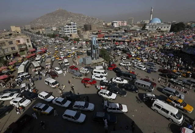 Vehicles drive at a junction in downtown Kabul August 25, 2014. (Photo by Mohammad Ismail/Reuters)