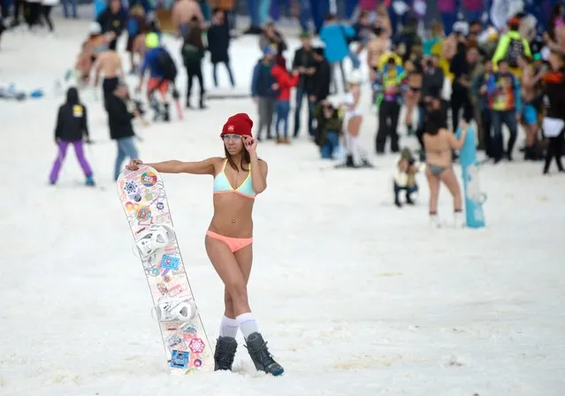 A girl in a swimsuit participates in the BoogelWoogel alpine carnival at the Rosa Khutor Alpine Resort in Krasnaya Polyana, Sochi, Russia on March 31, 2018. (Photo by Artur Lebedev/TASS)