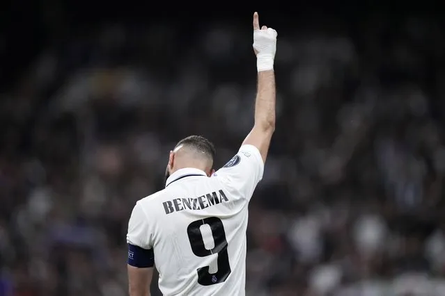 Real Madrid's Karim Benzema celebrates after scoring his sides first goal during the Champions League, round of 16, second leg soccer match between Real Madrid and Liverpool at the Santiago Bernabeu stadium in Madrid, Spain, Wednesday, March 15, 2023. (Photo by Bernat Armangue/AP Photo)