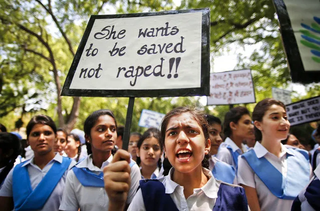 Students shout slogans as they hold placards demanding stringent punishment to rapists in New Delhi, India, on April 23, 2013. A second suspect was arrested in the rape of a 5-year-old girl who police said was left for dead in a locked room. (Photo by Saurabh Das/Associated Press)