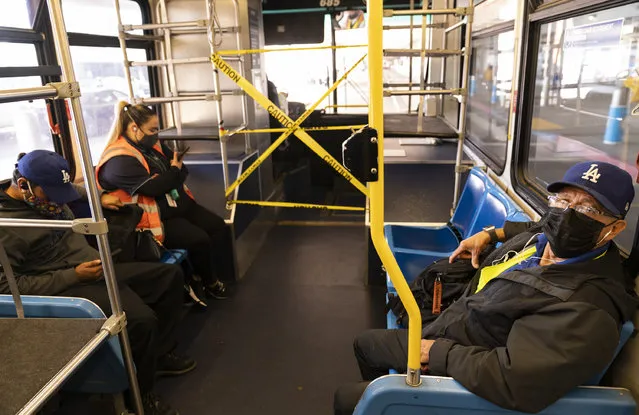 Airport workers take a shuttle bus between terminals at Los Angeles International Airport in Los Angeles, Wednesday, November 25, 2020. Residents were urged to avoid nonessential travel during what is typically the busiest travel period of the year. Anyone entering California was advised to quarantine for two weeks. (Photo by Damian Dovarganes/AP Photo)