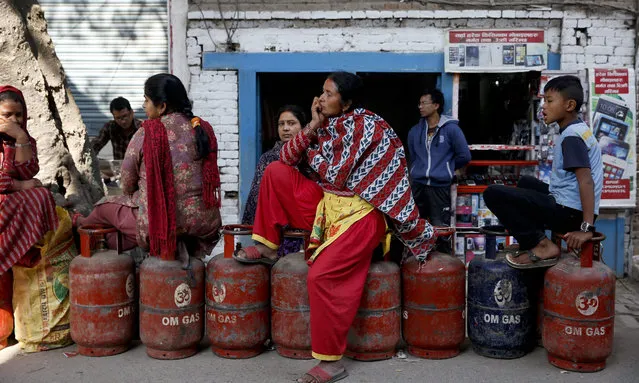 Nepalese households wait in a queue with their empty cooking gas cylinders for fresh supply in Kathmandu, Nepal, 03 November 2015. India, which supplies all of Nepal's fuel, closed its border with its neighbor 40 days ago, citing the danger posed by the anti-constitution protests. As a result, Nepal's fuel supplies have dried up, causing a scarcity of cooking gas and petrol. (Photo by Narendra Shrestha/EPA)