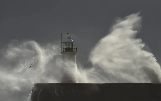 Waves and high winds hit the sea wall and light beacon at Newhaven in south England, Britain, November 18, 2015., 2015. (Photo by Toby Melville/Reuters)