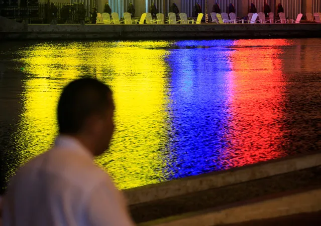 The colors of the Colombian flag are reflected in a canal next to the convention center in Cartagena, Colombia, September 26, 2016. (Photo by Jaime Saldarriaga/Reuters)