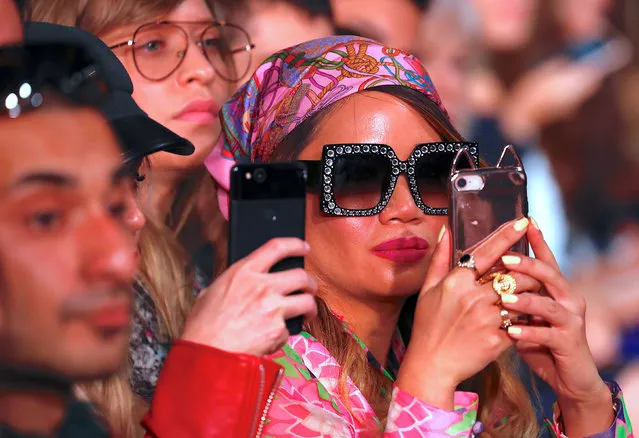 A member of the audience takes a photograph using her phone as models display designs by Australian fashion label Akira during a show at Australian Fashion Week in Sydney, Australia, May 17, 2018. (Photo by David Gray/Reuters)