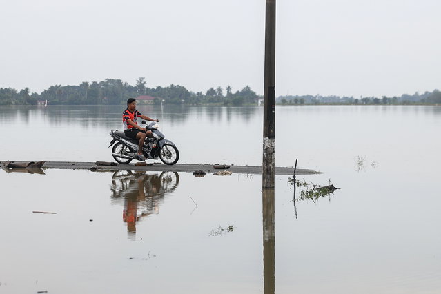 A motorcyclist passes by floodwaters at the town of Kangar, state of Perlis, Malaysia, 28 November 2025. Earlier reports noted that rare tropical storm “Senyar” was expected to bring persistent heavy rain and strong winds to the west coast of Peninsular Malaysia, raising the risk of several days of adverse weather. (Photo by Fazry Ismail/EPA)