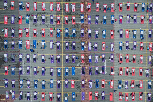 Yoga practitioners take part in a mass yoga session organised by the High Commission of India at Batu Caves on June 21, 2023 in Gombak, Selangor, Malaysia. The event was held as part of the 9th International Day of Yoga. (Photo by Annice Lyn/Getty Images)