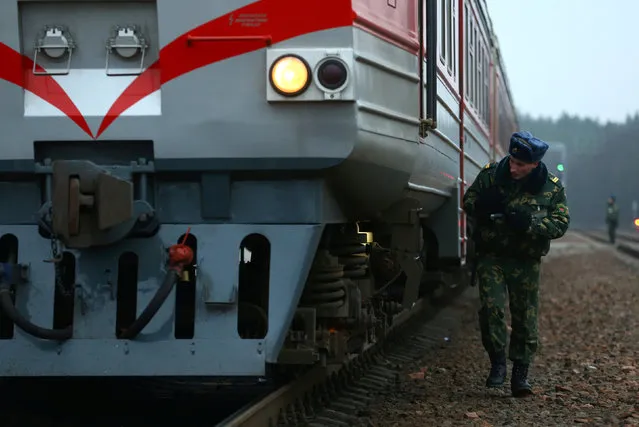 A Belarussian border guard checks a train after it arrived from Lithuania, at the railway station Gudogai, Belarus, November 22, 2016. (Photo by Vasily Fedosenko/Reuters)